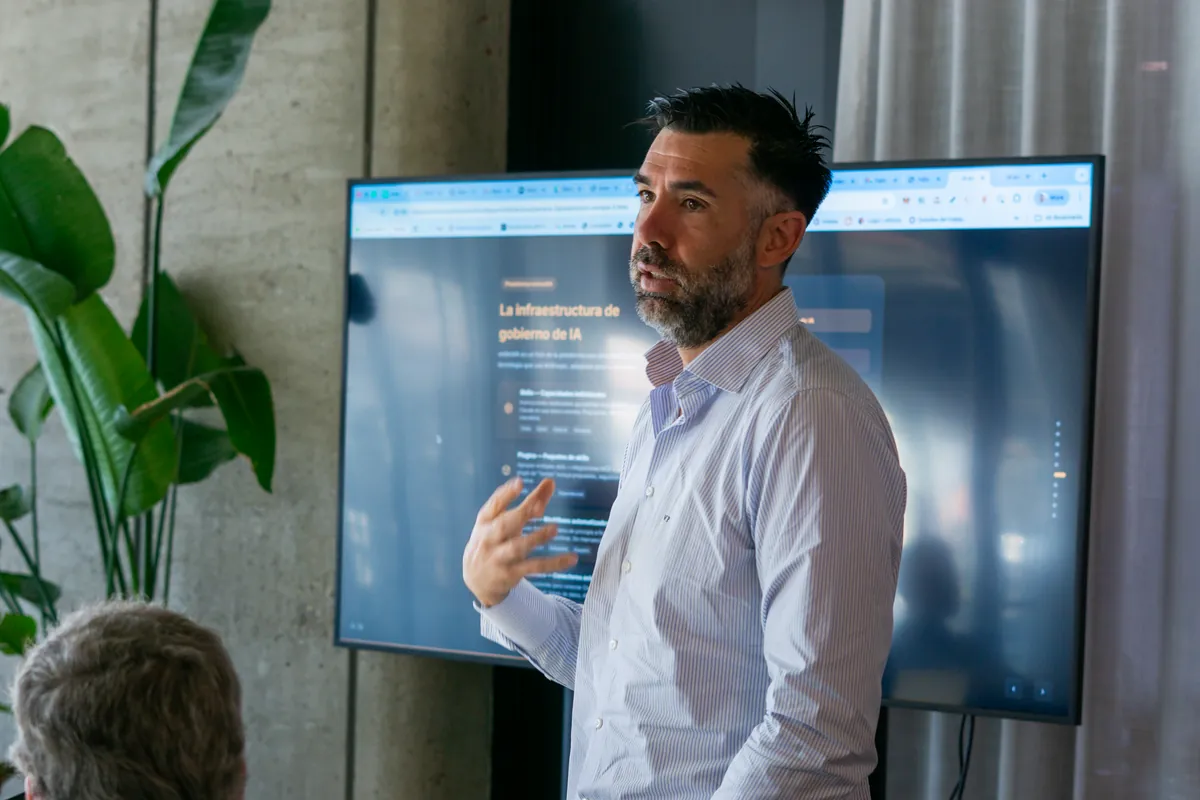 Trainer leading an in-person AI governance training session in front of a screen